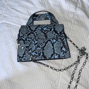 Blue snakeskin print bag with silver chair